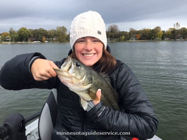 Angler holding bass on the boat
